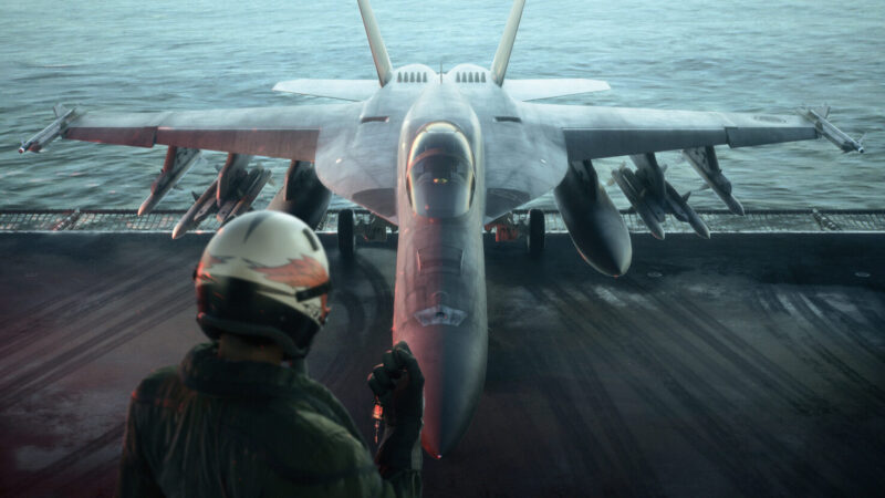 Ace Combat 8 Wings of Theve library hero artwork of a fighter jet banking over a warzone